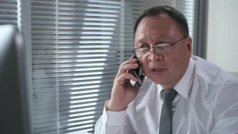 Professional-Asian-Businessman-in-Shirt-and-Tie-Talking-on-Phone