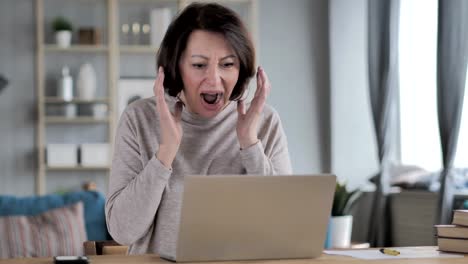 Shocked,-Stunned-Old-Senior-Woman-Wondering-and-Working-on-Laptop