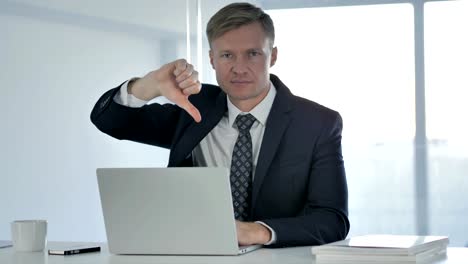 Thumbs-Down-by-Businessman-Looking-at-Camera