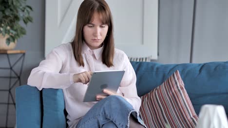 Casual-Mädchen-mittels-Tablet-auf-Couch