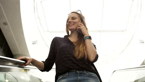 Businesswoman-Having-a-Nice-Phone-Call-on-the-Escalator