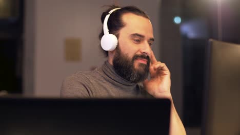 creative-man-with-headphones-working-at-office