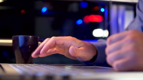 Hands-of-a-man-working-by-computer-late-night