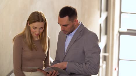 businesswoman-and-businessman-discussing-documents