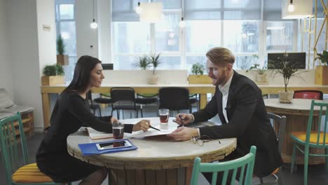 Business-Partners-at-the-meeting.-Lady-discusses-strategy-with-a-man