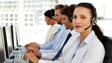 Happy-call-centre-agent-looking-to-camera