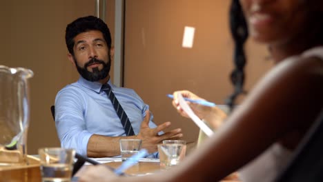 Middle-aged-male-manager-talking-to-team-at-business-meeting