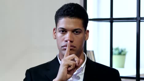 Gesture-of-Silence-by-Black-Businessman,-Finger-on-Lips