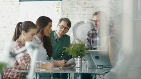 In-Creative-Bureau-Sitting-at-Conference-Table-Group-of-Six-Coworkers-Solve-Daily-Business-Problems.