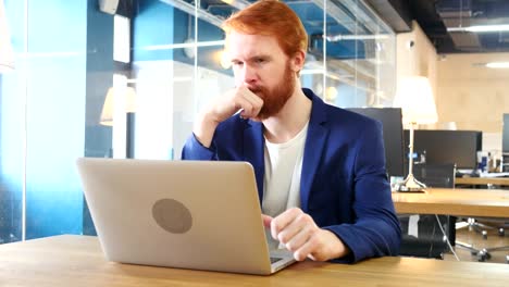 Man-Thinking-and-Working-on-Laptop,-Red-Hairs