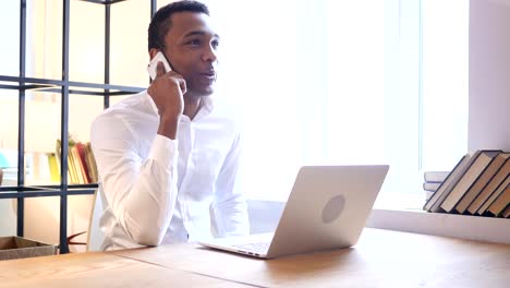 Black-Man-Talking-on-Phone-at-Work