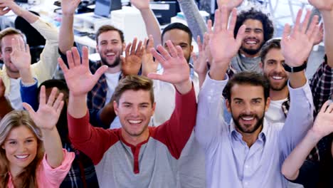 Portrait-of-business-team-gesturing-together-in-office