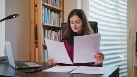 Cheerful-Young-Woman-Looking-on-Documents