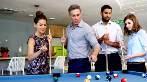 Executives-playing-pool-in-office