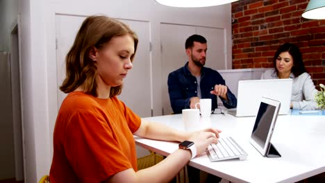 Female-executive-working-at-desk