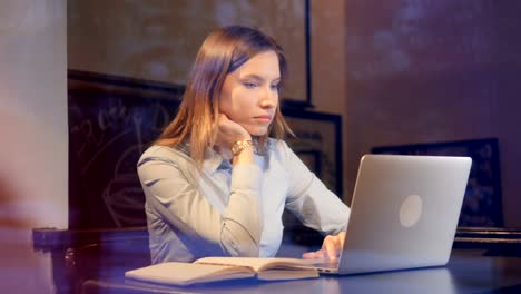 The-portrait-of-the-girl-working-at-the-laptop-at-late-night.-Slider.-Close-up.-4K.