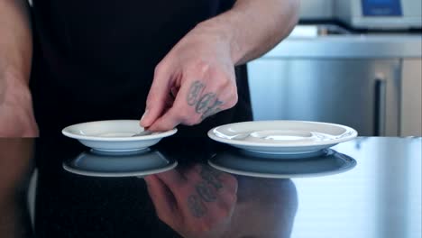 Happy-barista-offering-two-cups-of-coffee-to-camera-in-a-cafe