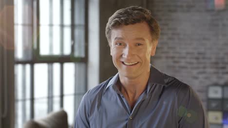 Slow-Motion-Portrait-of-Happy-Cute-Caucasian-Man-Laughing-at-Office-Room.-Businessman-Series.