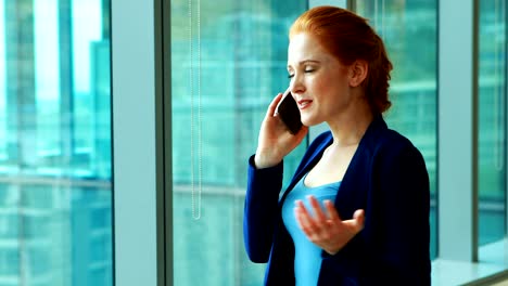 Female-executive-talking-on-mobile-phone