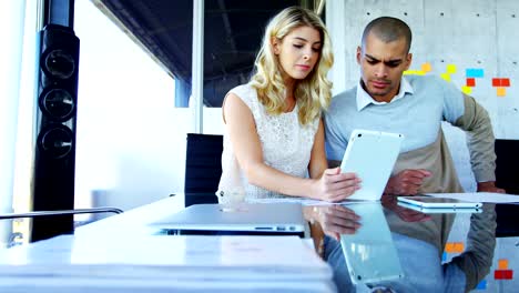 Colleagues-using-digital-tablet-at-table-4k