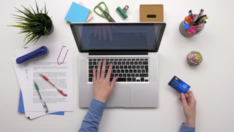 Overhead-Top-view-Of-Businesswoman-Using-Laptop-And-Credit-Card