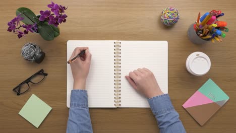 Overhead-Top-View-Of-woman-Making-To-Do-List-In-Diary