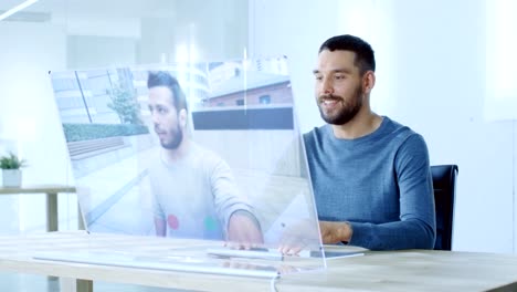 In-the-Near-Future-Man-Makes-Video-Call-from-Computer-with-Transparent-Display-to-His-Friend.-They-Have-Friendly-Chat.-Office-Design-is-Modern-and-Bright.