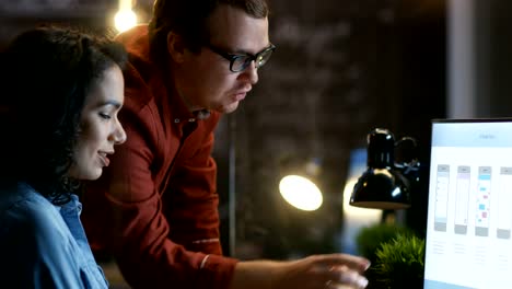 Beautiful-Female-Mobile-Gaming-Application-Developer-Talks-With-Her-Male-Colleague,-They-Discuss-Creative-Design.-Stylishly-Lit-Office.