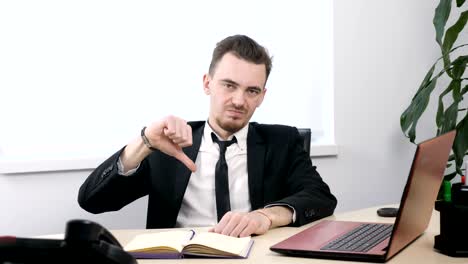 Young-businessman-in-suit-sitting-in-office-and-showing-thumbs-up-sign-60-fps