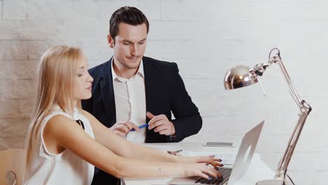 man-and-woman-are-looking-at-the-computer-in-the-office