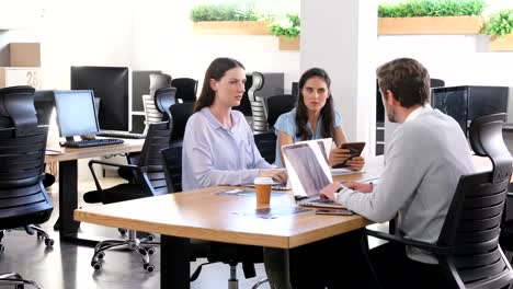 Executive-discussing-with-each-other-while-using-laptop-4k