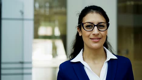 Portrait-of-successful-businesswoman-in-glasses-smiling-in-modern-office