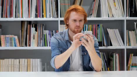 Man-Using-Smartphone,-Browsing-online-at-Work