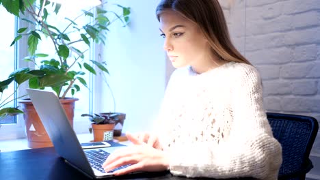 Young-Female-Working-on-Laptop-in-Office