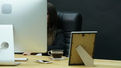 Young-attractive-businesswoman-having-headache-in-the-office