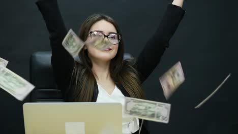 Beautiful-young-businesswoman-is-counting-money,-fanning-herself-with-dollars,-laughing-and-throwing-them-in-the-air