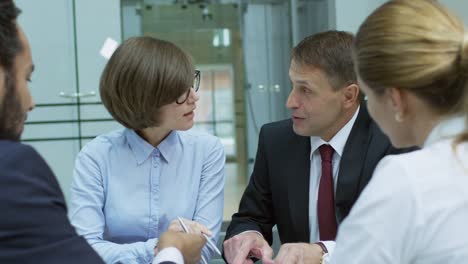 Business-Professionals-Discussing-Documents