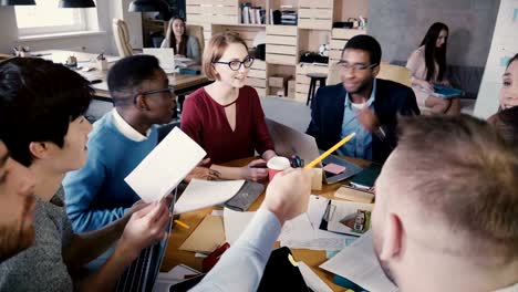 Business-people-brainstorm-at-office-meeting.-Happy-creative-multiracial-sales-agency-staff-smiling-and-talking-4K