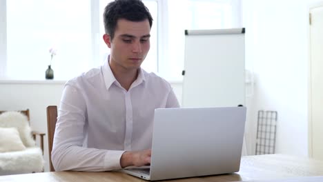 Businessman-Working-On-Laptop-in-Office