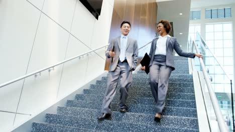 Multi-ethnic-male-female-real-estate-team-meeting