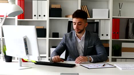 frustrated-businessman-in-suit-coat-typing-on-keyboard