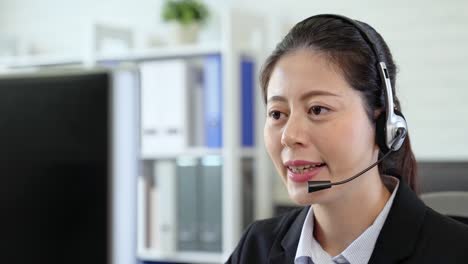 Asian-girl-sitting-at-computer-with-the-headphone