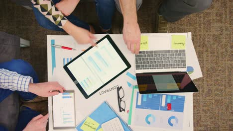 Overhead-Of-Entrepreneurs-Discussing-Financial-Data-While-Working-On-Wireless-Technologies-4K