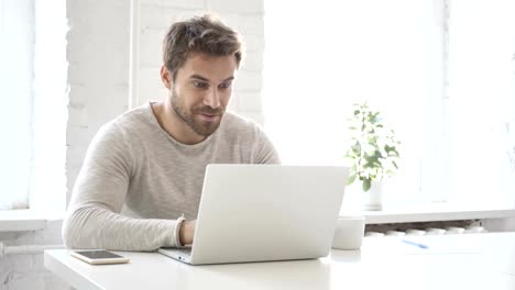 Businessman-Celebrating-Success,-Working-on-Laptop