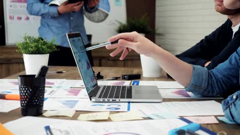 Team-of-young-business-managers-analyzing-data-using-computer-in-the-office