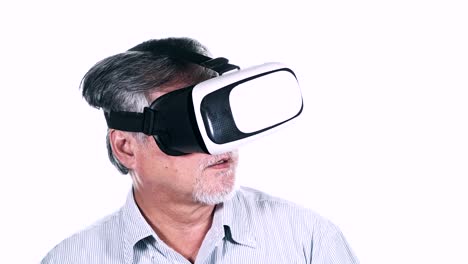 Old-man-trying-on-VR-head-set-isolated-on-white-background.-Senior-asian-man-wiith-VR-headset,-exciting-look.-Senior-lifestyle-concept.