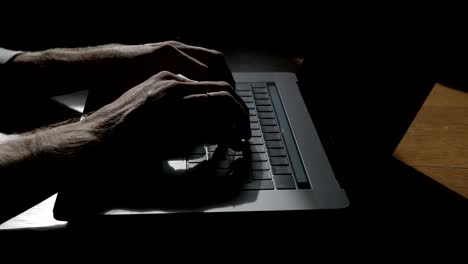 Man-Hands-Typing-On-Keyboard-Of-Modern-Laptop-On-Wooden-Table.