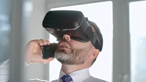 Businessman-in-VR-Goggles-Talking-on-Phone