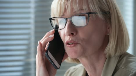 Close-Up-of-Mid-aged-Businesswoman-Talking-on-Phone