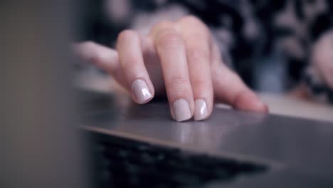 Female-is-Writing-and-Working-on-a-Laptop